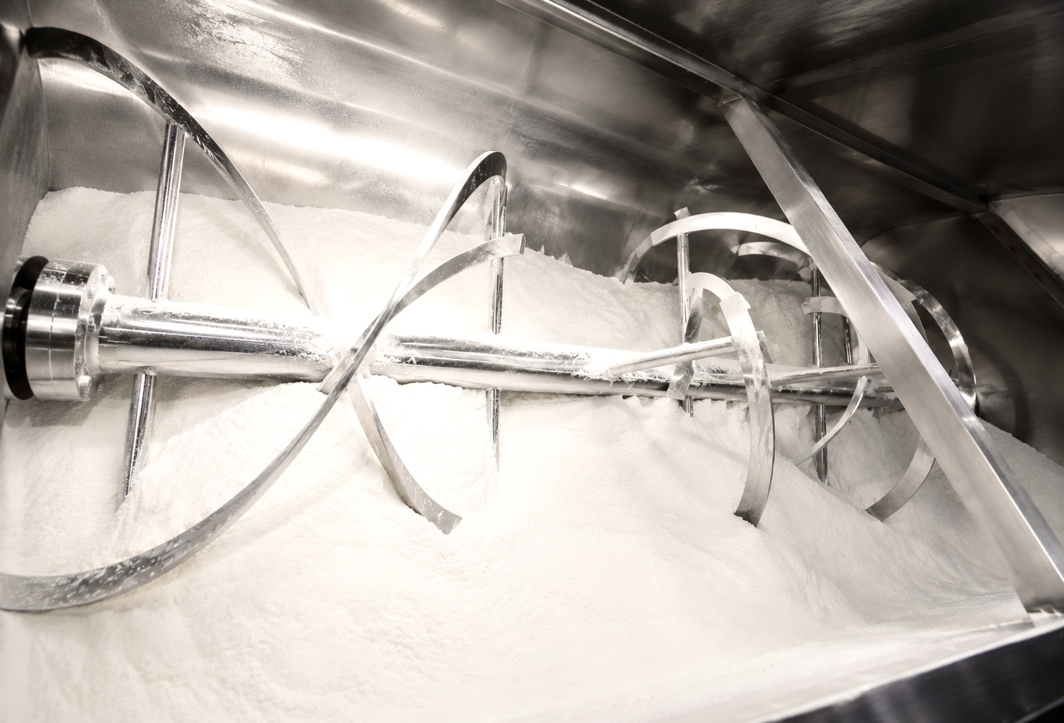 Inside a charged ribbon blender mixing dry chemical powders